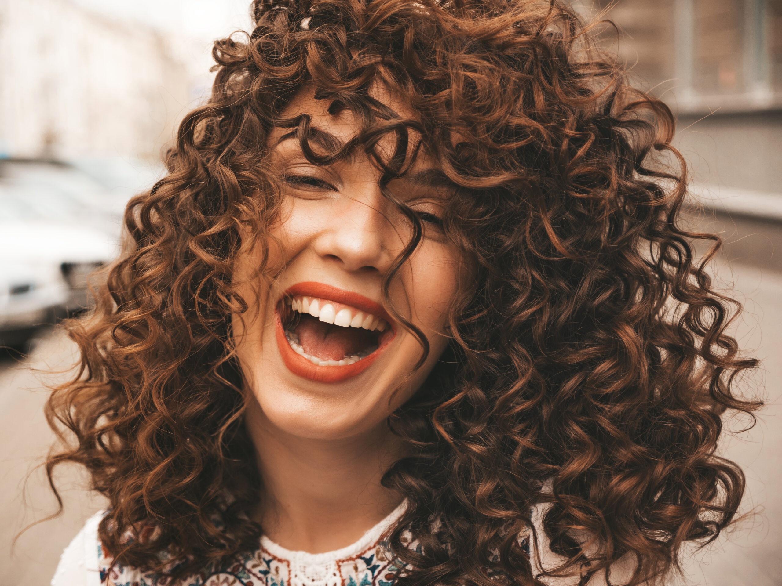 mulher sorridente com cachos perfeitos